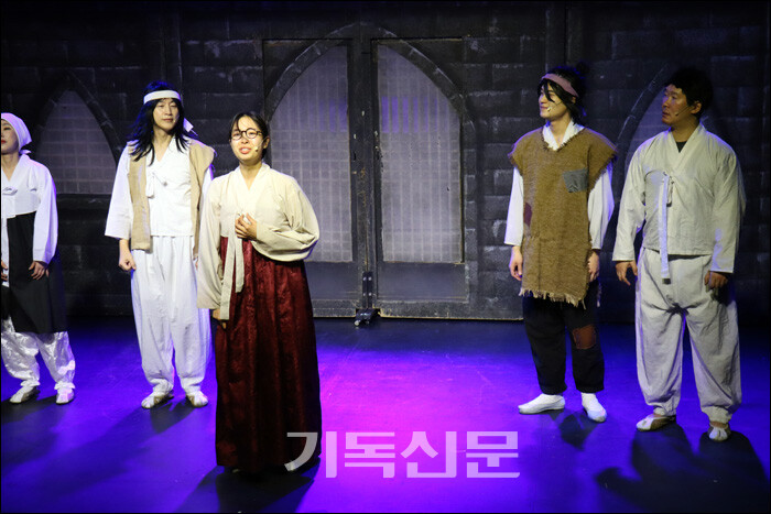 한 전도부인에게서 성경을 선물받으며 기독교 신앙에 입문하게 되는 문준경 전도사의 모습을 연출한 뮤지컬 [문준경] 무대의 한 장면.